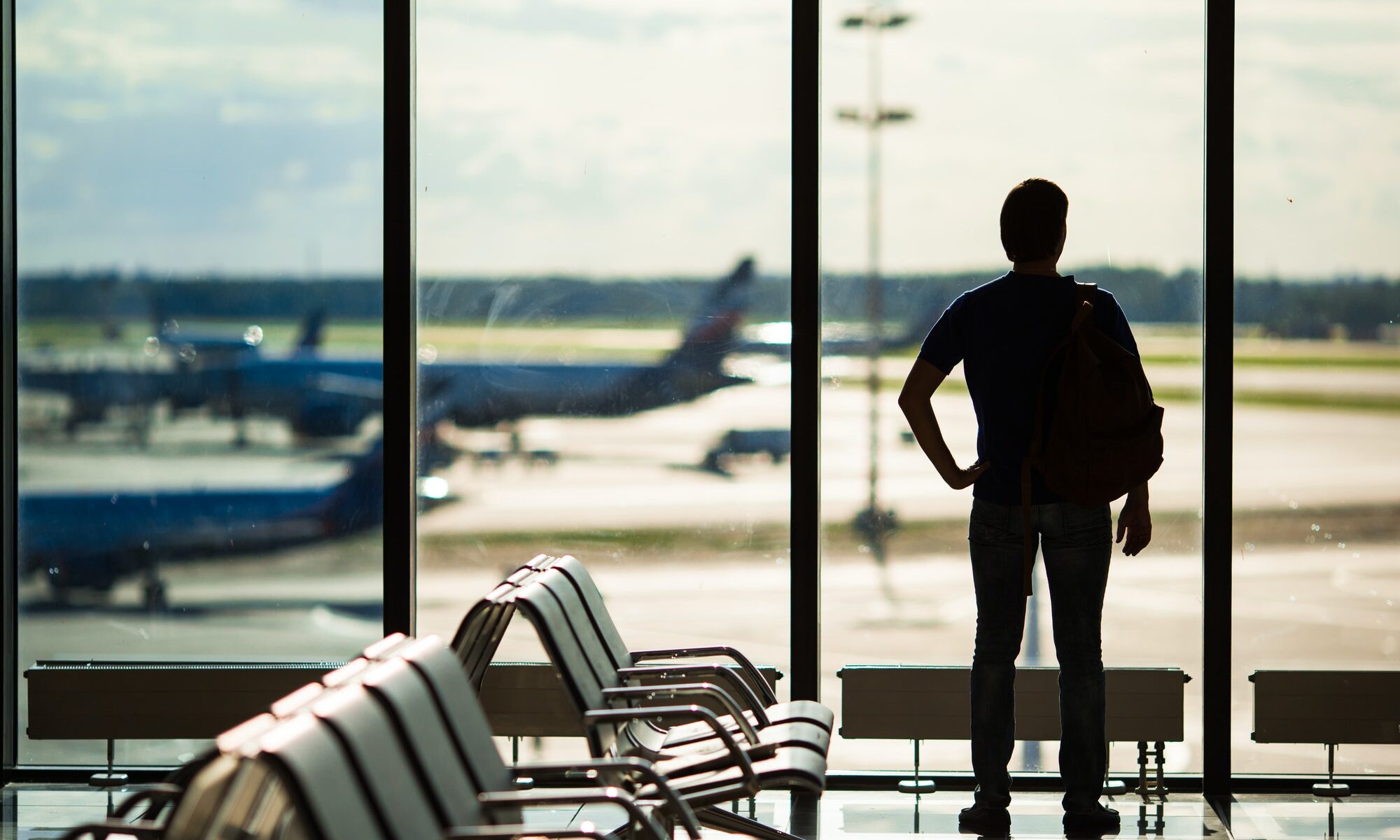 Silhouette of a man waiting to board a flight in airport